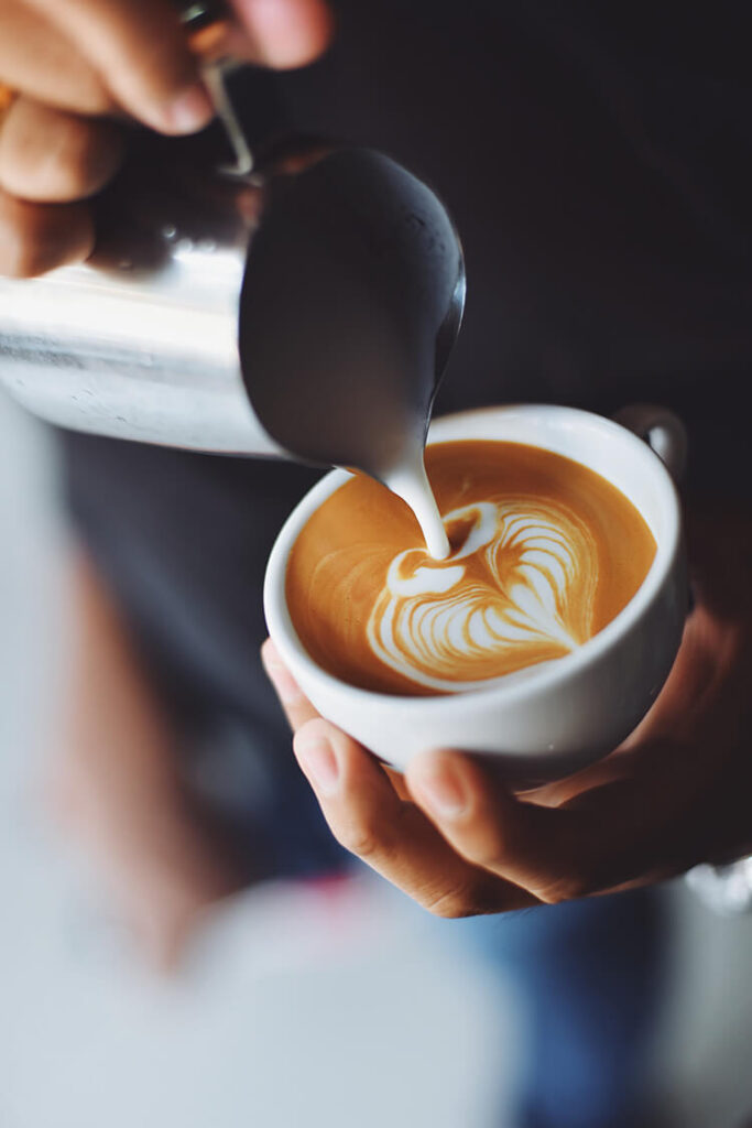 person serving cup coffee 1